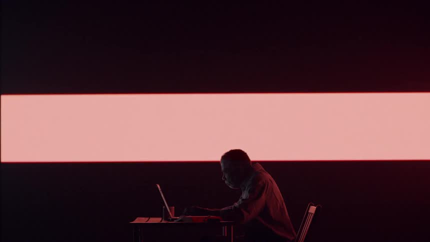 A man works in front of LED wall