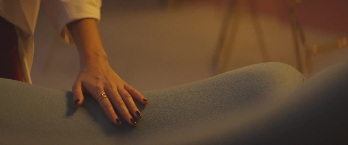 Woman rubs her hand on a chair