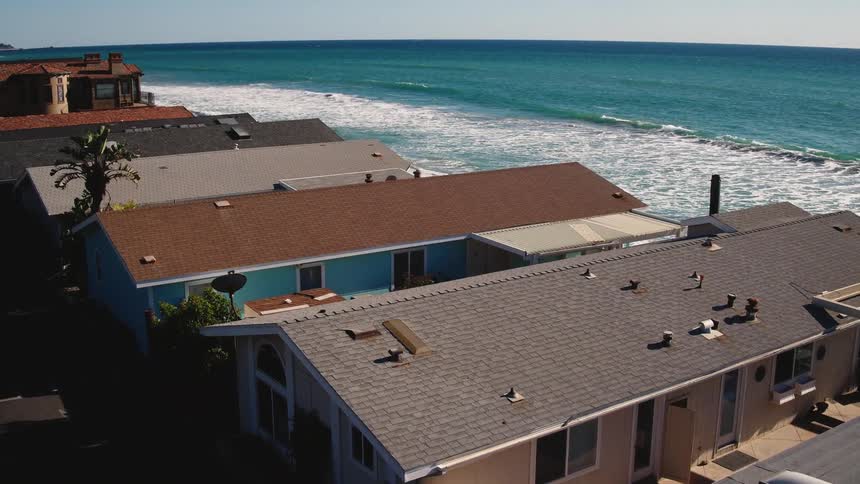 Ocean waves flow near beach houses
