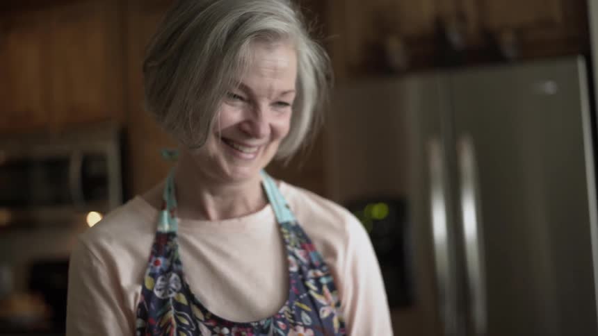 An older woman smiles at a little girl