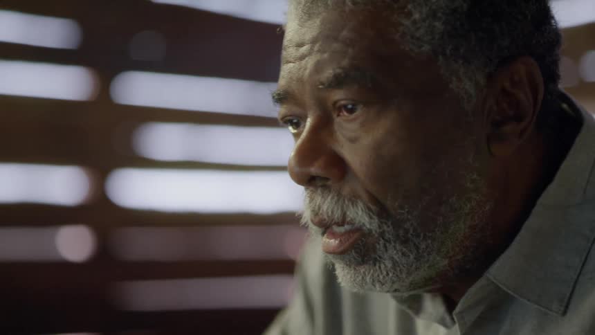 A man is sitting down looking at something