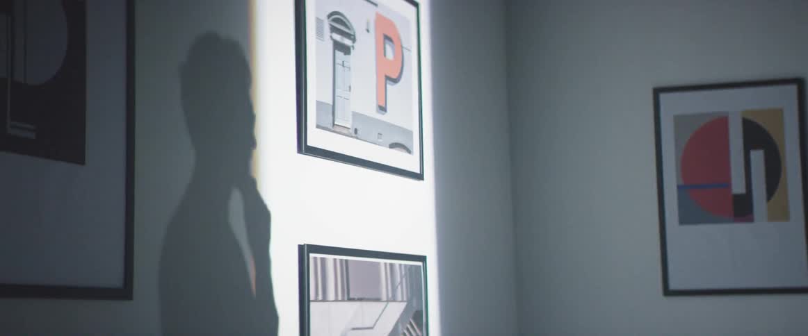A person's shadow is on the wall briefly