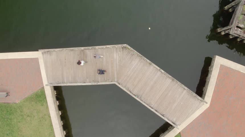 People ride scooters on a waterfront