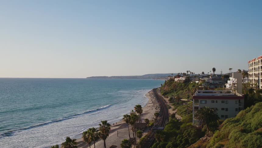 The ocean town is lined with palm trees