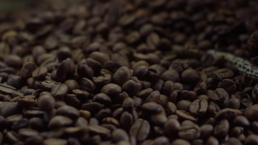 Coffee beans fall into a pile