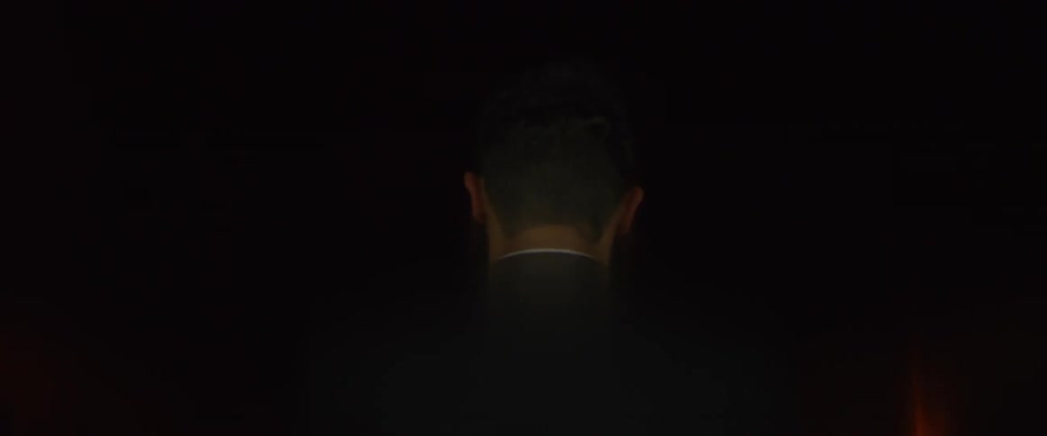 Man walking away turns back
