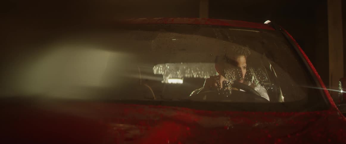 Man looking around while sitting in a car