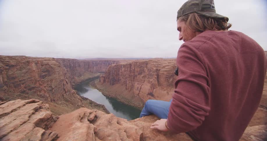 A person sitting on a cliff edge