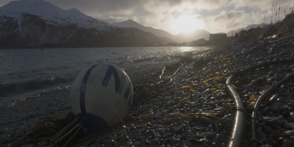 The sun sets over coastal mountains