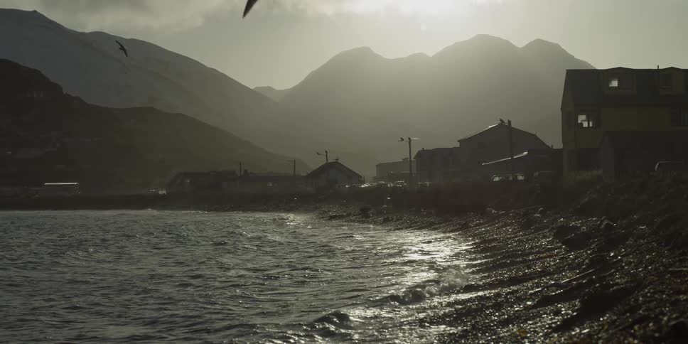 Waves roll onto a gravelly beach