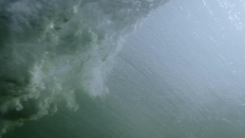 Ocean waves crash down into the sea