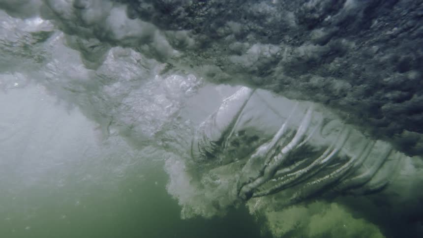 Ocean waves crash down into the sea
