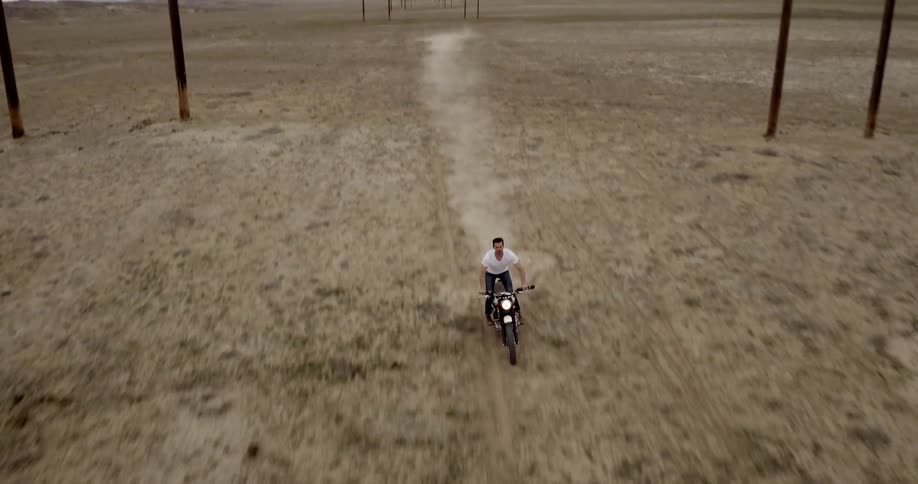Man driving motorcycle through the desert