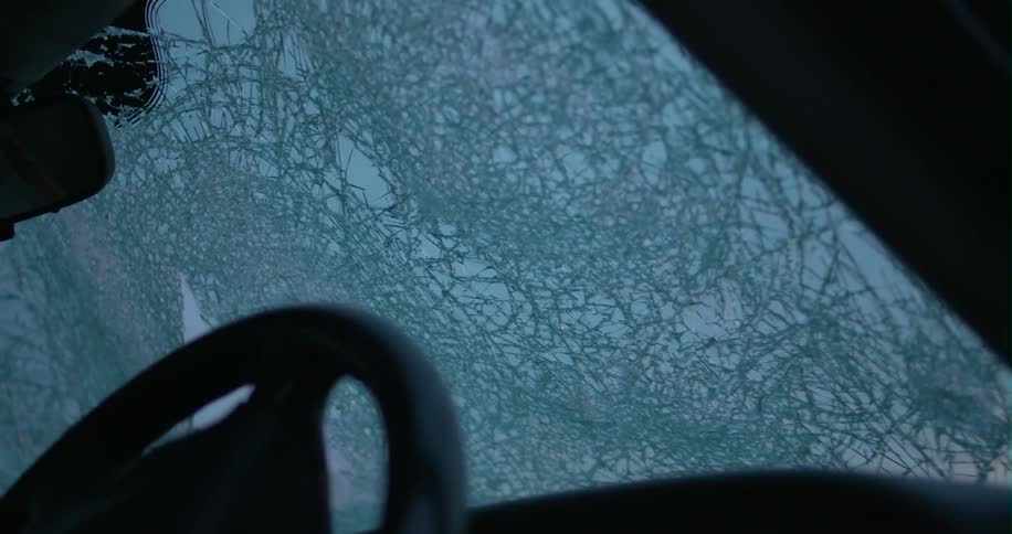 A baseball bat smashes a car windshield
