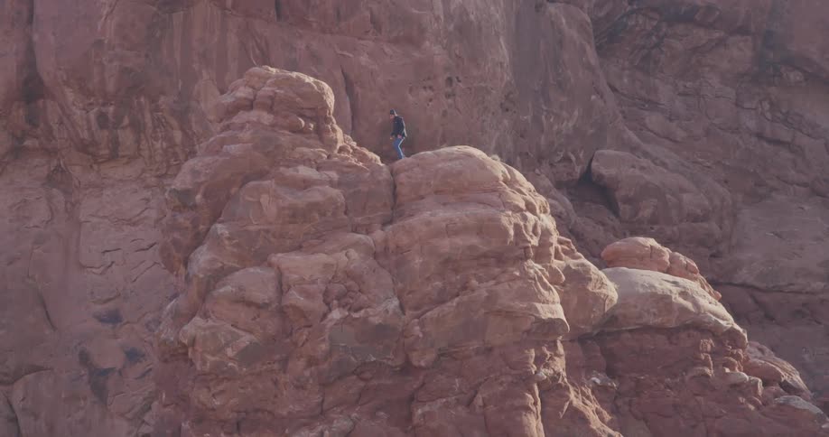 A person climbing a cliff side