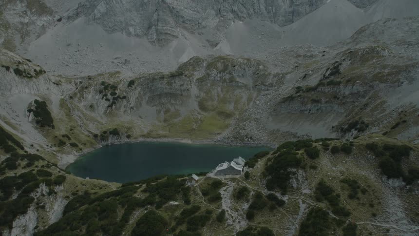 A mountain lake is ringed by cliffs