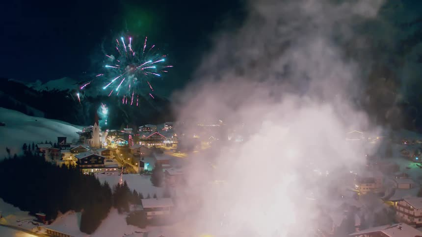 Fireworks explode over a mountain village