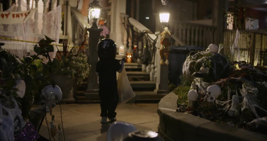 A child in costume is trick or treating