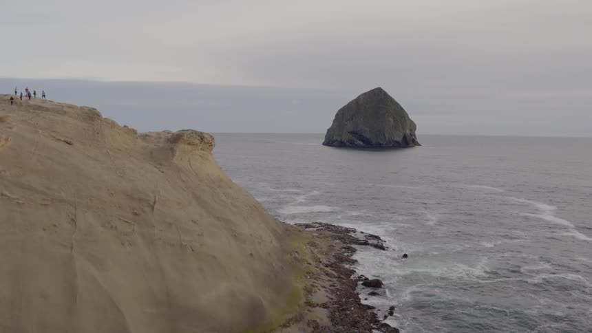 Waves flow towards the rocky shore