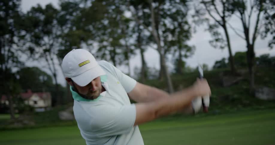 A man takes a swing on a golf course