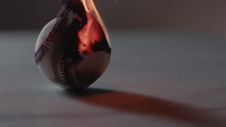 A baseball burns in an empty room