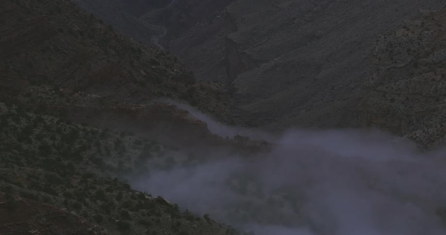 Clouds rolling thru a valley