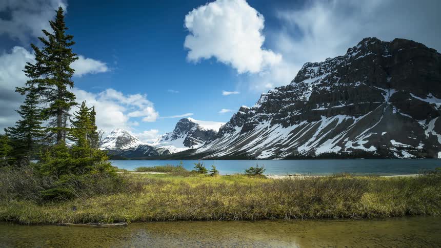 Tall mountain rising over Bow Lake in Banff, Canada
