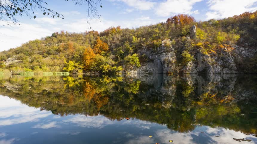 The forest is perfectly reflected in the calm Plitvice lake in Croatia