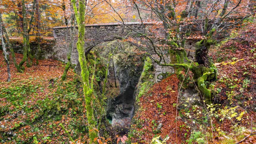 The old cobblestone bridge gaps the Mostnica Gorge in Slovenia