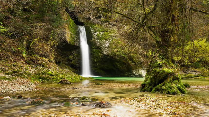 Grmecica Waterfall splashing into a shallow stream in Slovenia