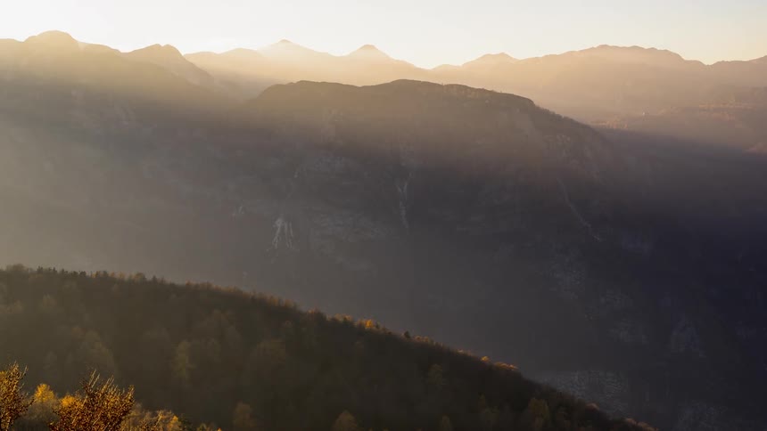 The sun shines brightly on the tall Vogel mountain in Slovenia