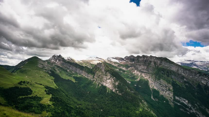 Clouds pass above the mountains
