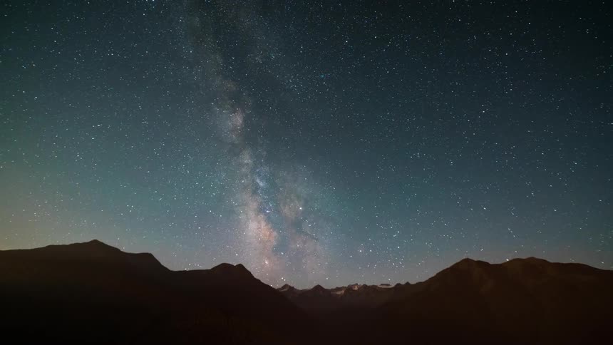 The Milky Way slowly moving over mountain tops at sunrise