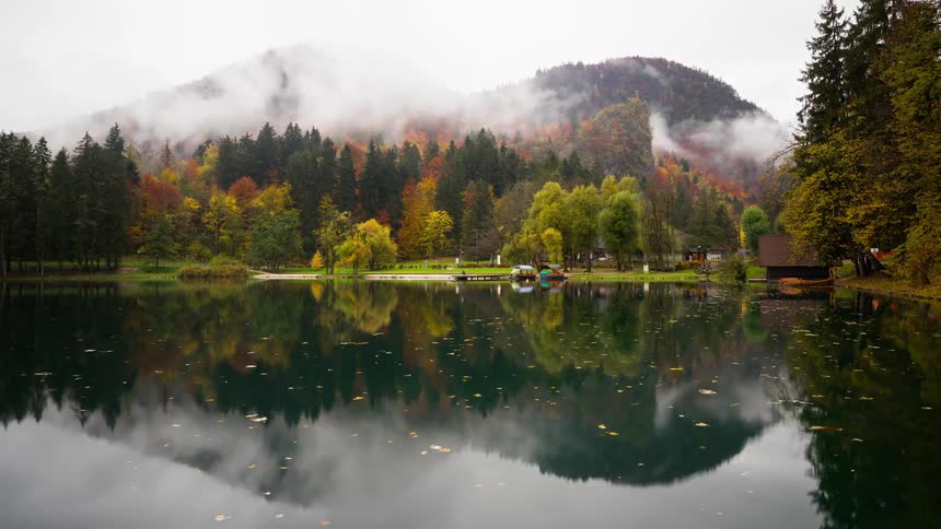 People get on their small boats in the lake Bled in Slovenia and ride off