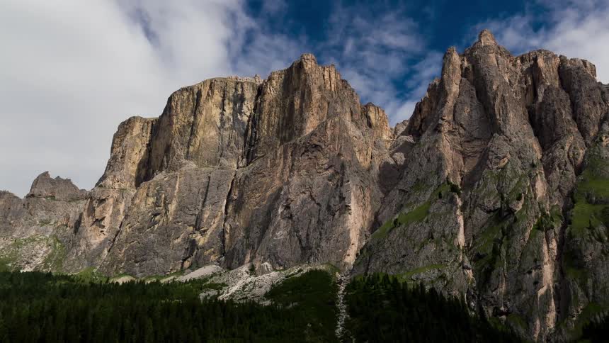 Clouds pass over the tall stone mountains