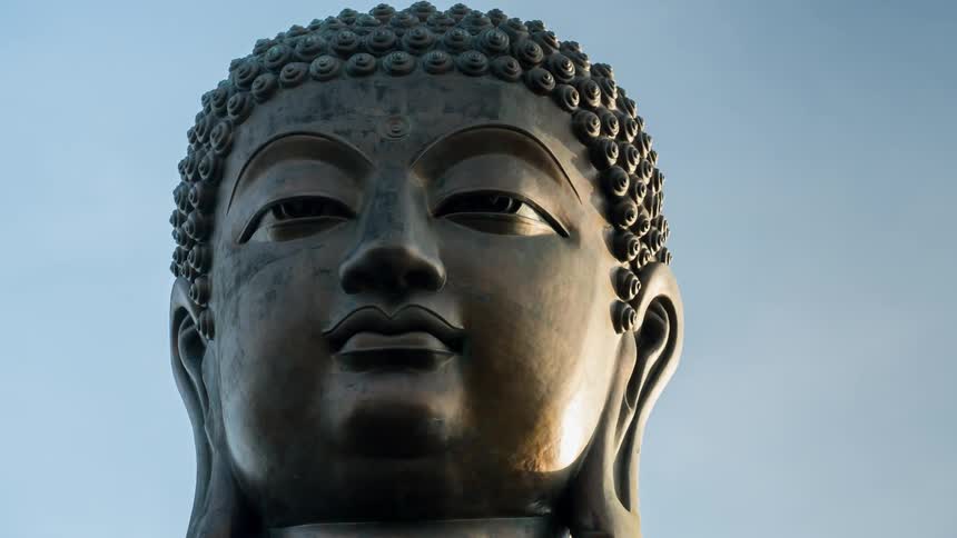Sunlight shines on a statue of buddha