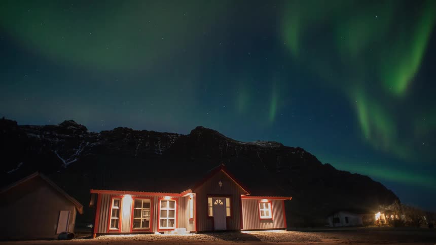 Time lapse of the aurora above a house