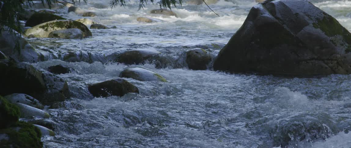 Water gushes down river rapids