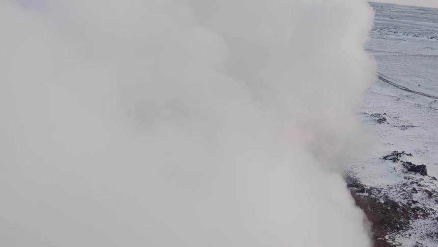 Steam plumes from a frozen mountain