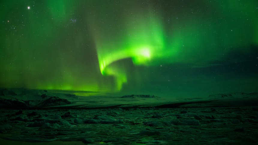 The sky waves with green flares