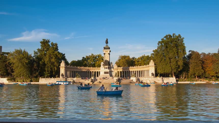 Boats on the city lake in Retiro park on a sunny day