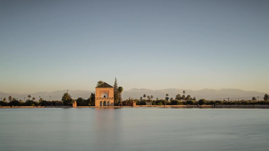 Time lapse of a calm lake on a clear day fading into night