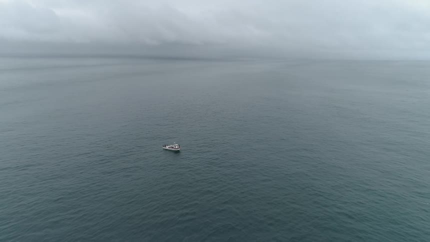 A boat sails on an ocean