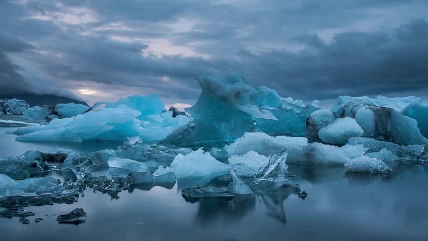 Icebergs shift as clouds speed past