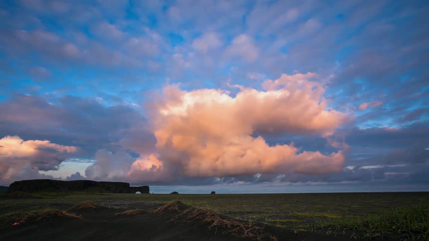 The large clouds spin over the field ahead