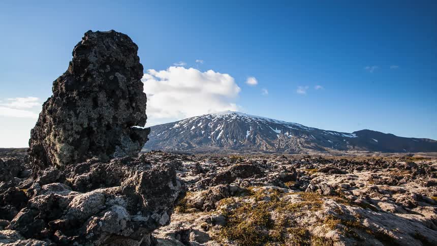 The mountain ahead has snow at the top