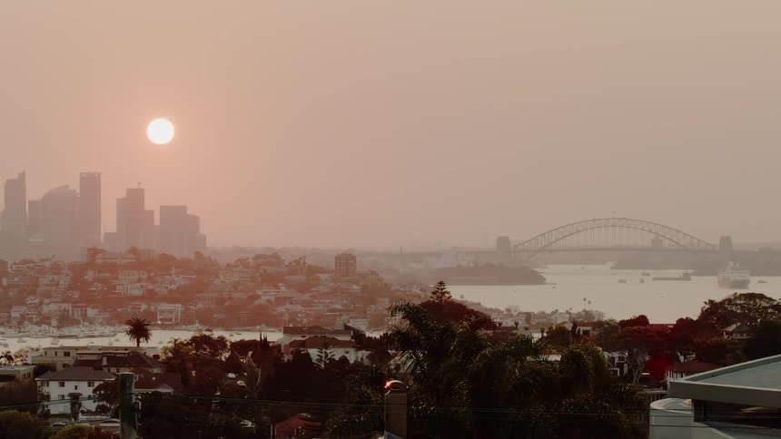 The sun sets over a city