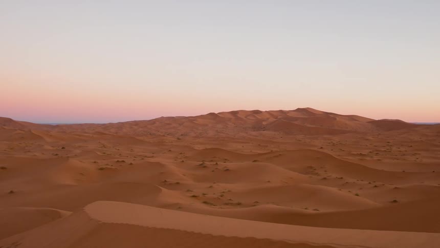 Time lapse of the sun rising over the desert of Sahara