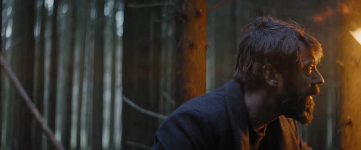 Man holds a torch in a forest