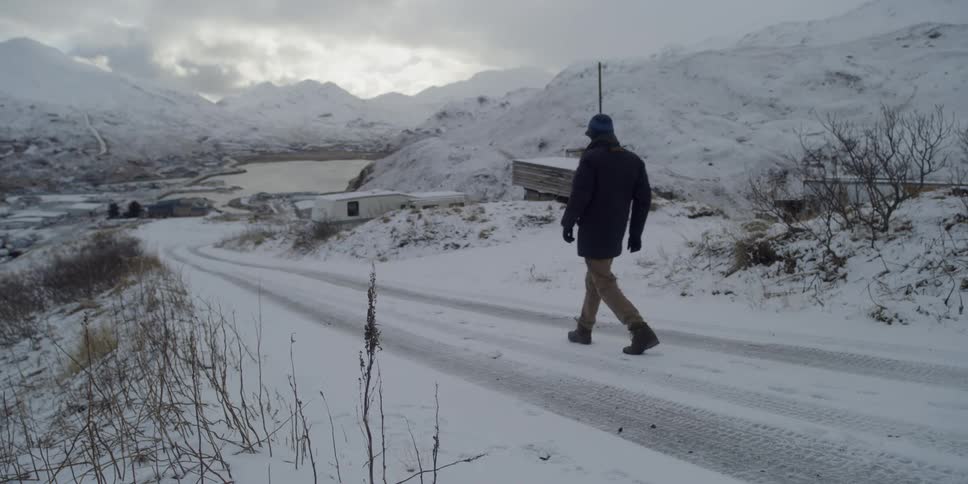 Man walks down a snowy street